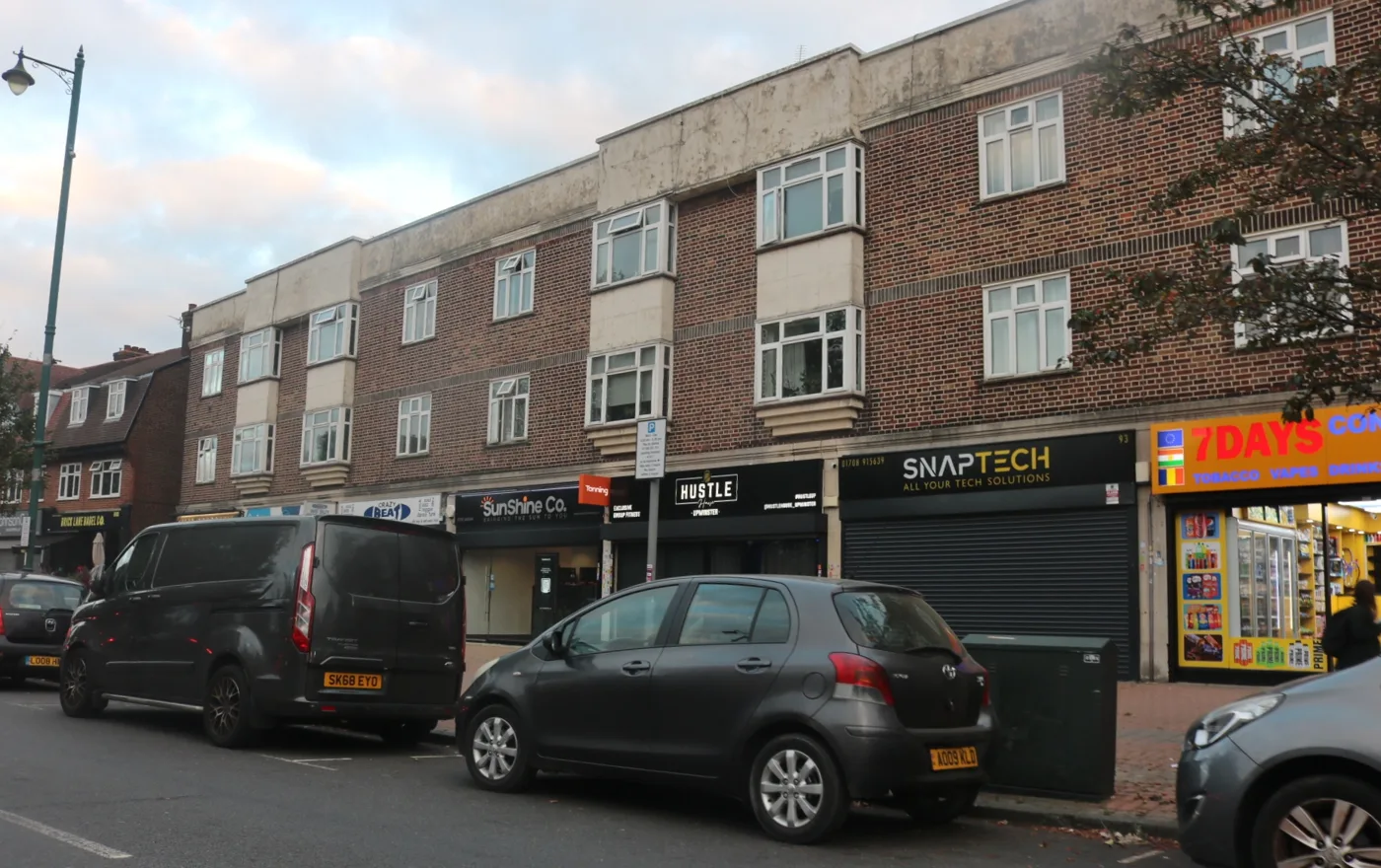 Shops on Corbets Tey Road, Upminster, photographed on 8 October 2025, nearly a year before the raid. A shop signed 7 Days stands at the right of the parade.