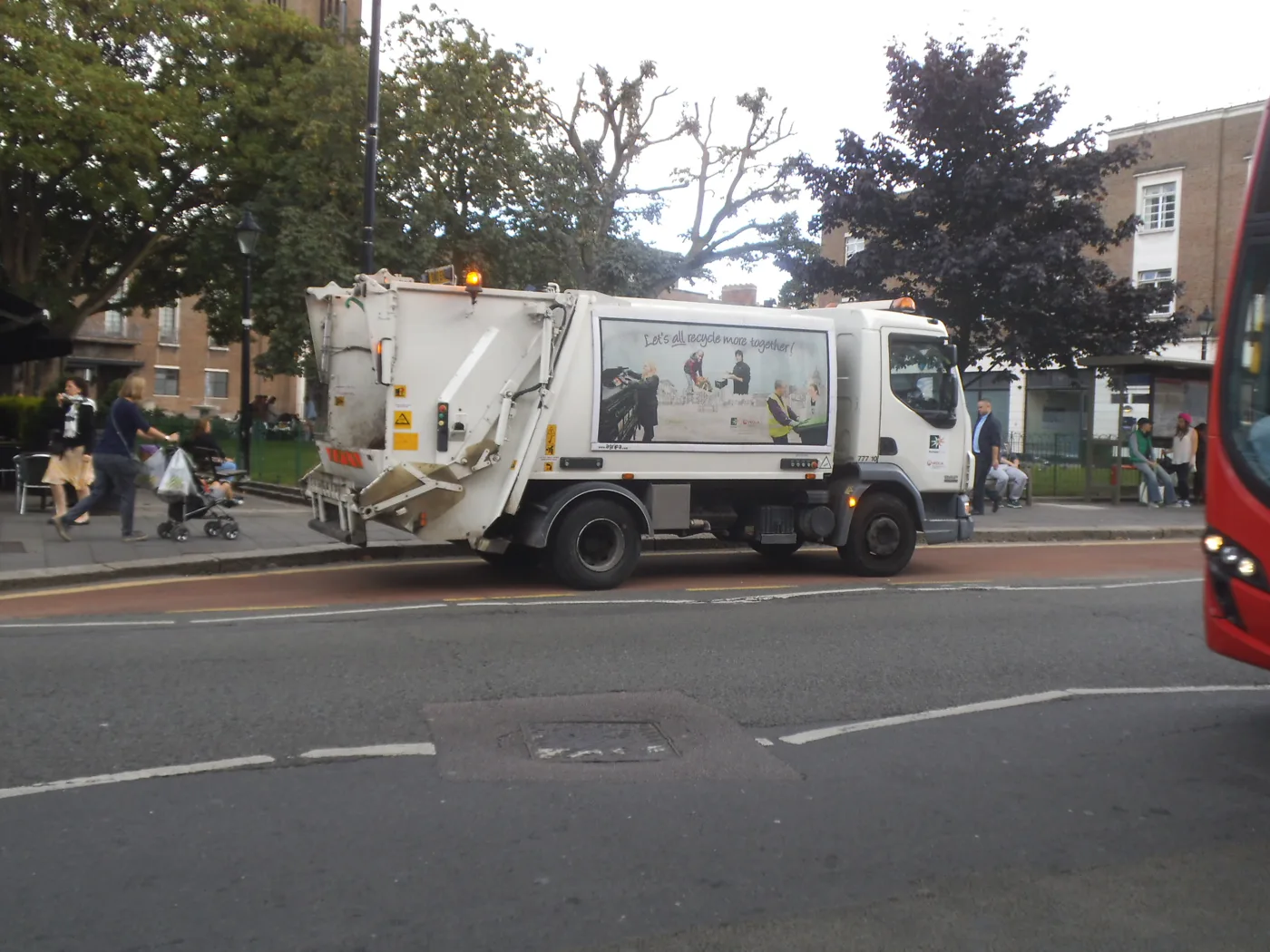 A refuse lorry on a London high street. The picture is not in Havering and does not show an FCC vehicle.